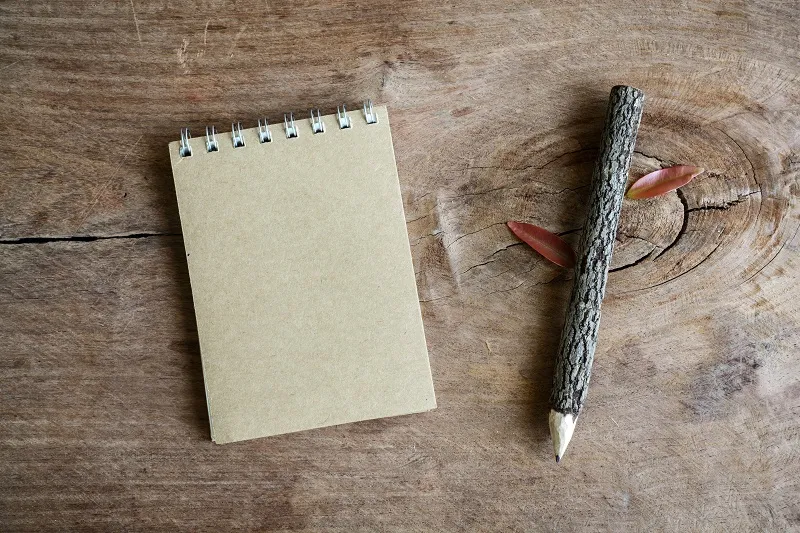 Recycle Notebook With Wooden Pencil On Old Wooden Table